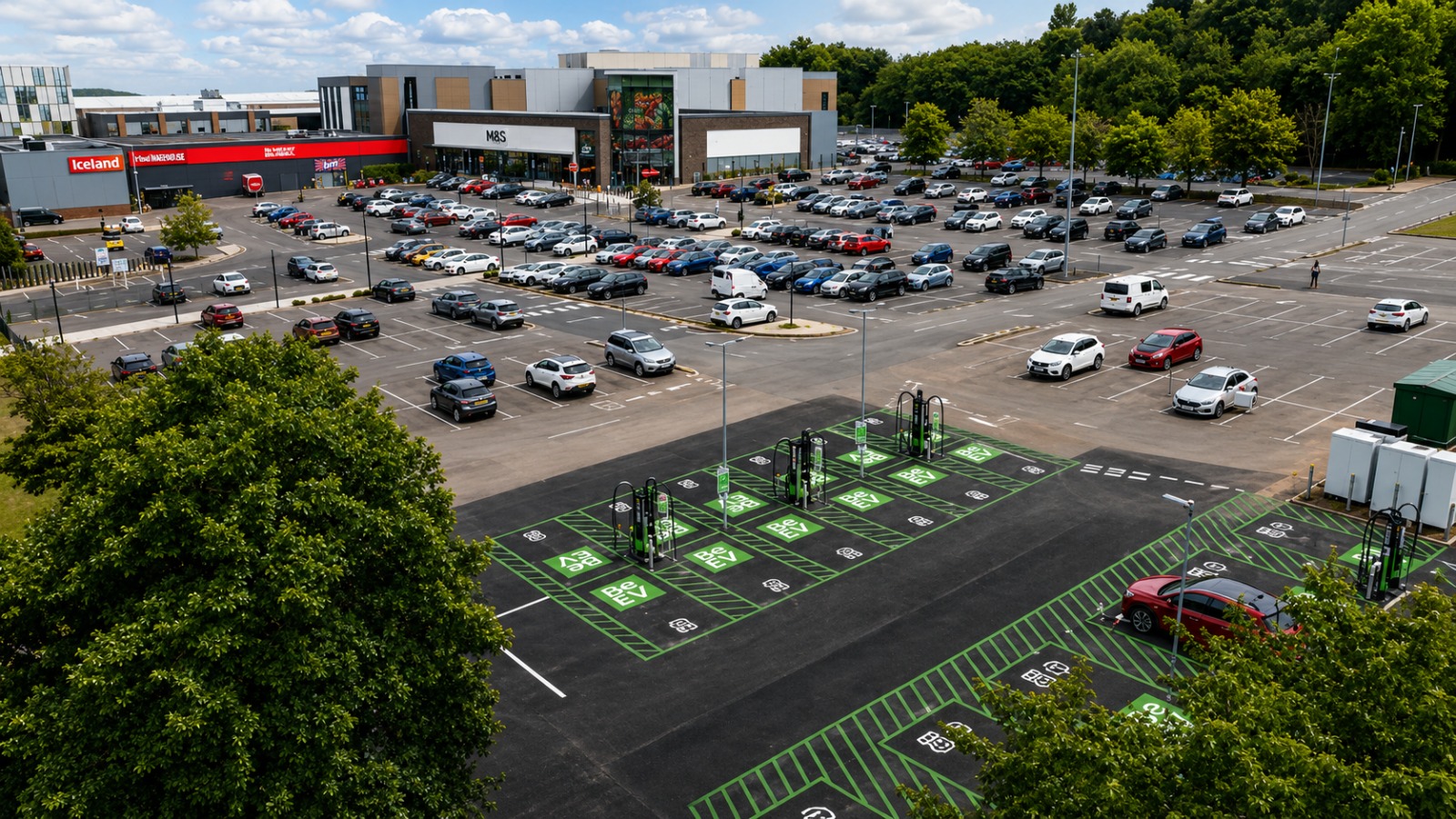 Aerial view of EV charging bays within a retail park car park