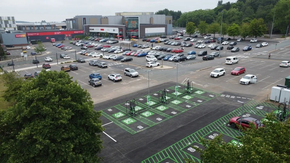 Aerial view of a multi-bay EV charging installation at a retail park