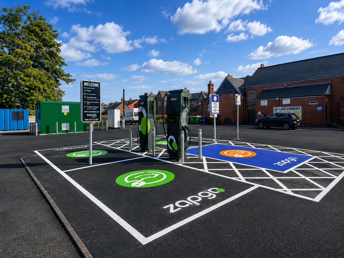 Two EV charging units in a public car park under a blue sky
